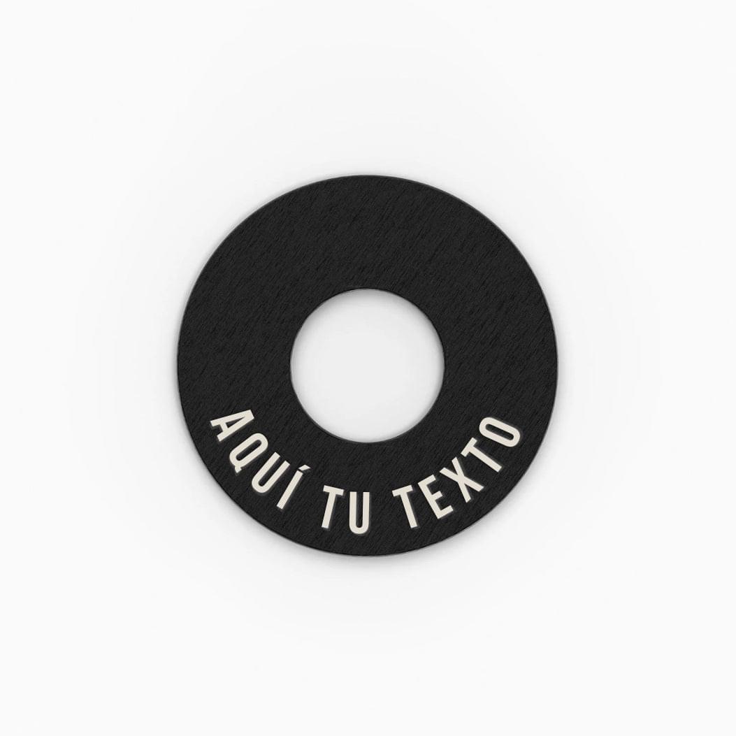 Anilla® negra con el texto AQUÍ TU TEXTO grabado como muestra de personalización