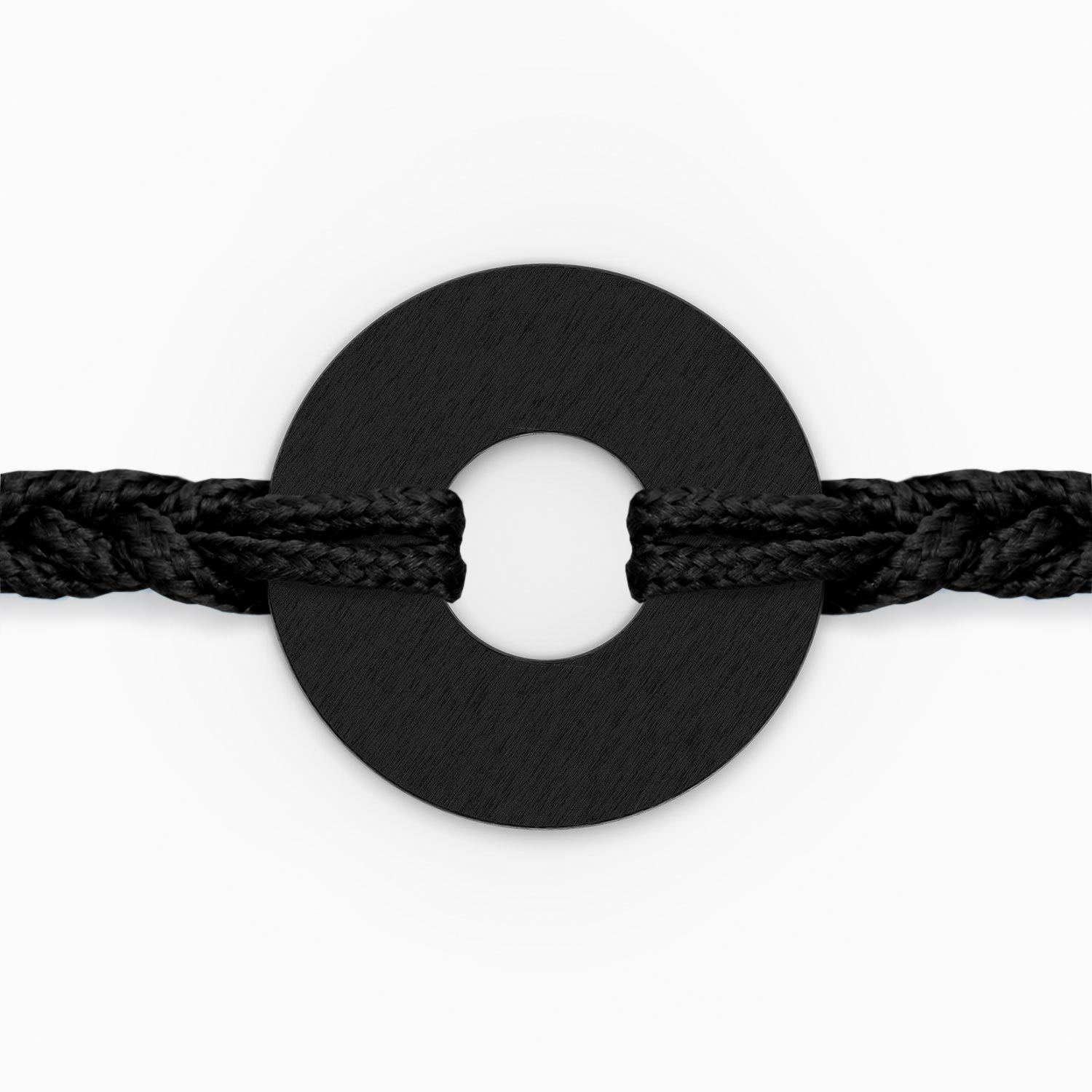 Detalle macro de la anilla negra ensartada en el cordón trenzado de la MyWord®