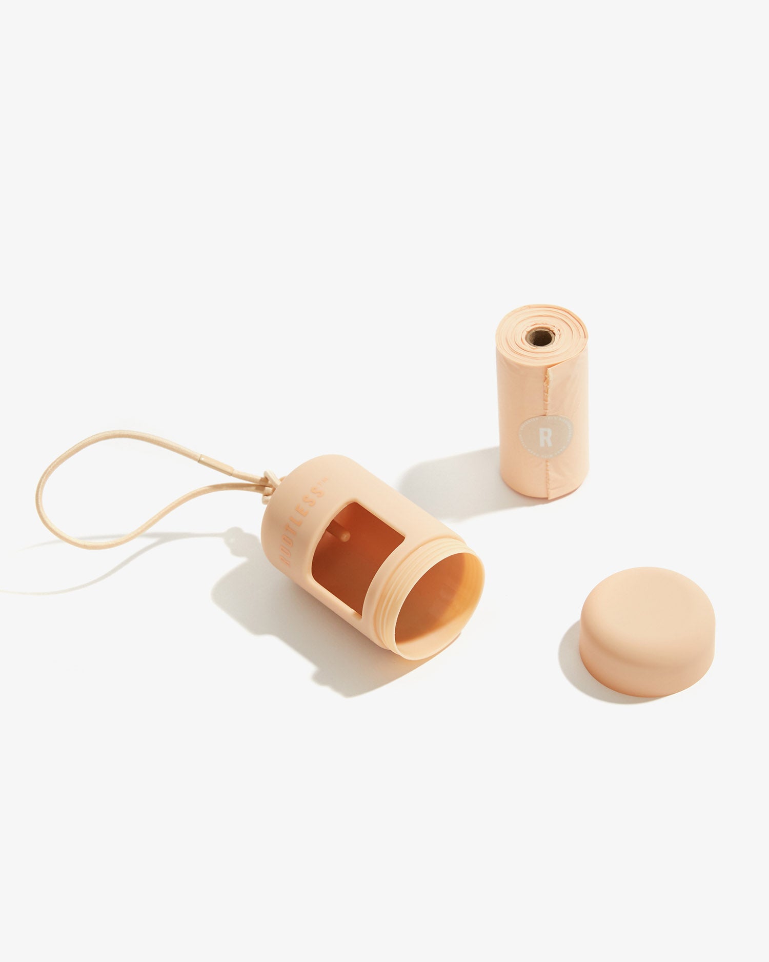 Portabolsas EasyFlex™ nude abierto con la tapa y el rollo de bolsas al lado